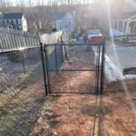 a fenced in area with a fence and a house